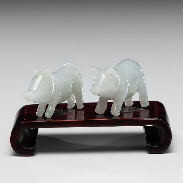 Appraisal: Chinese Two carved white and green jadeite pigs Lg in