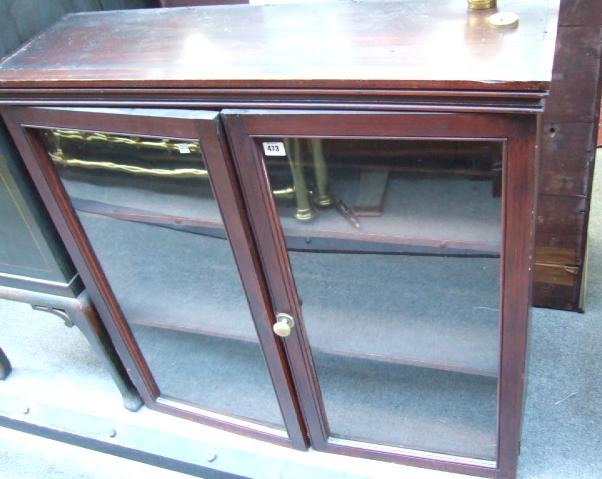 Appraisal: A late th century stained mahogany glazed two door cabinet