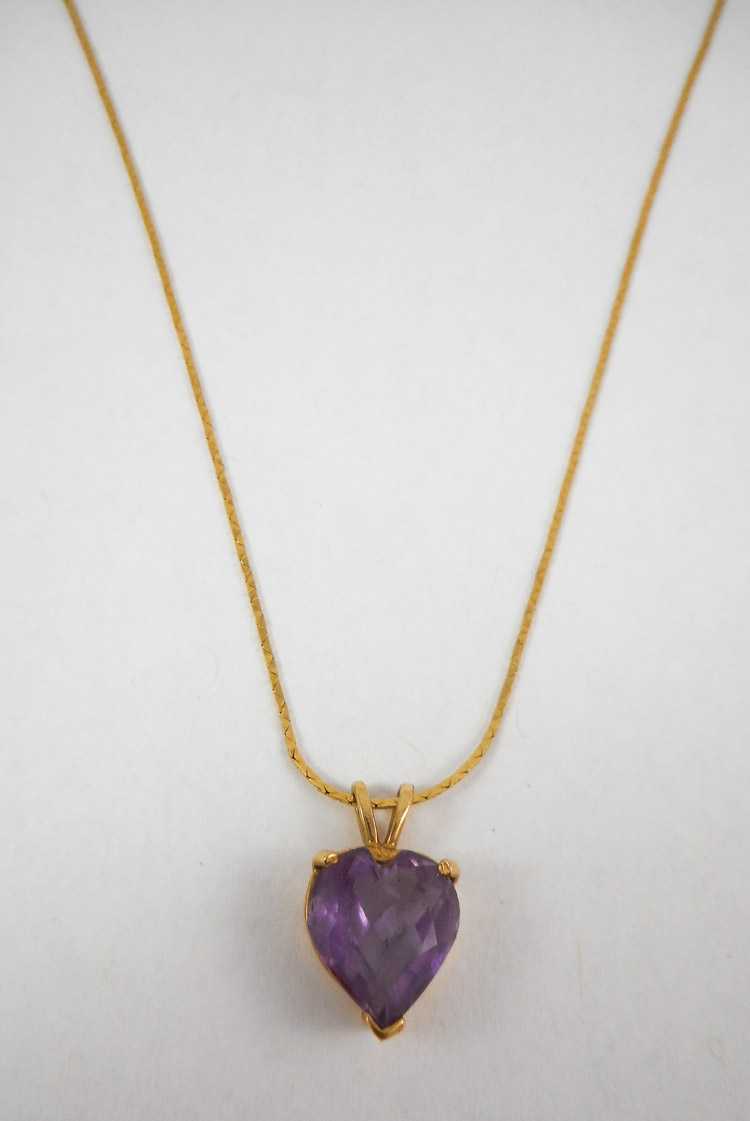 Appraisal: AMETHYST AND FOURTEEN KARAT GOLD PENDANT NECKLACE suspended on a