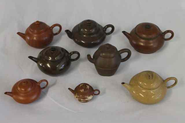 Appraisal: A COLLECTION OF SIX YIXING TEAPOTS to include a small