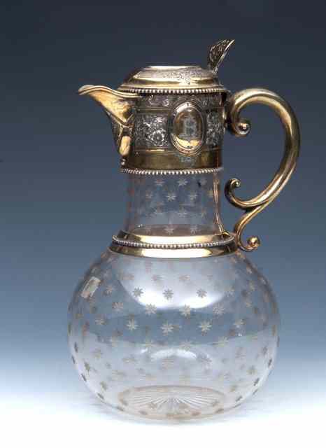 Appraisal: A VICTORIAN SILVER GILT MOUNTED CLARET JUG the body decorated