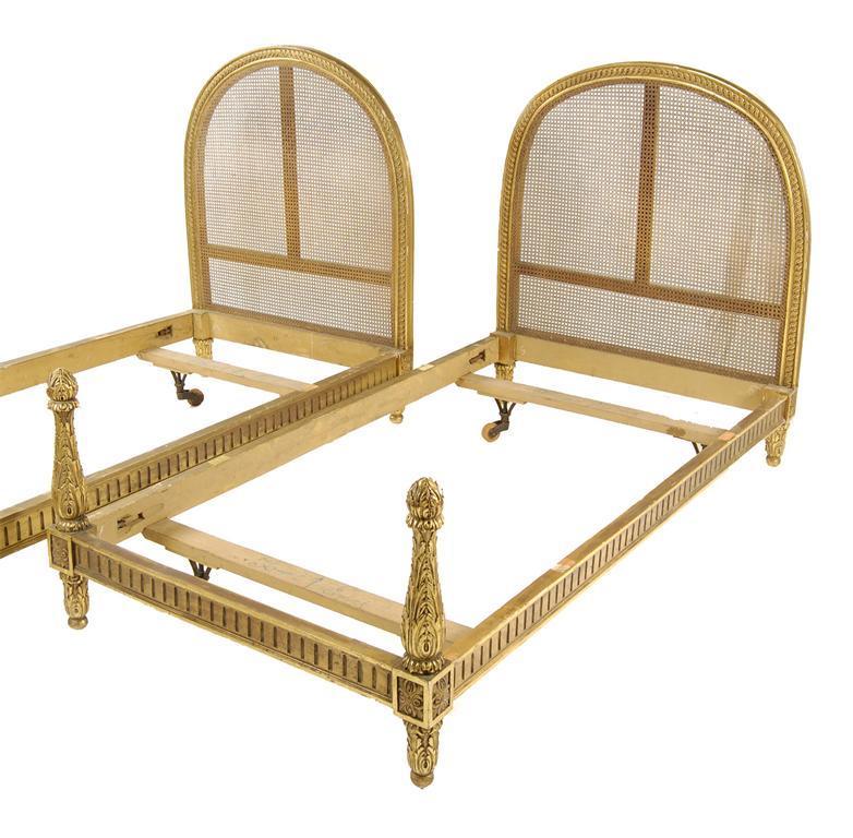 Appraisal: A pair of continental giltwood single bedsteads