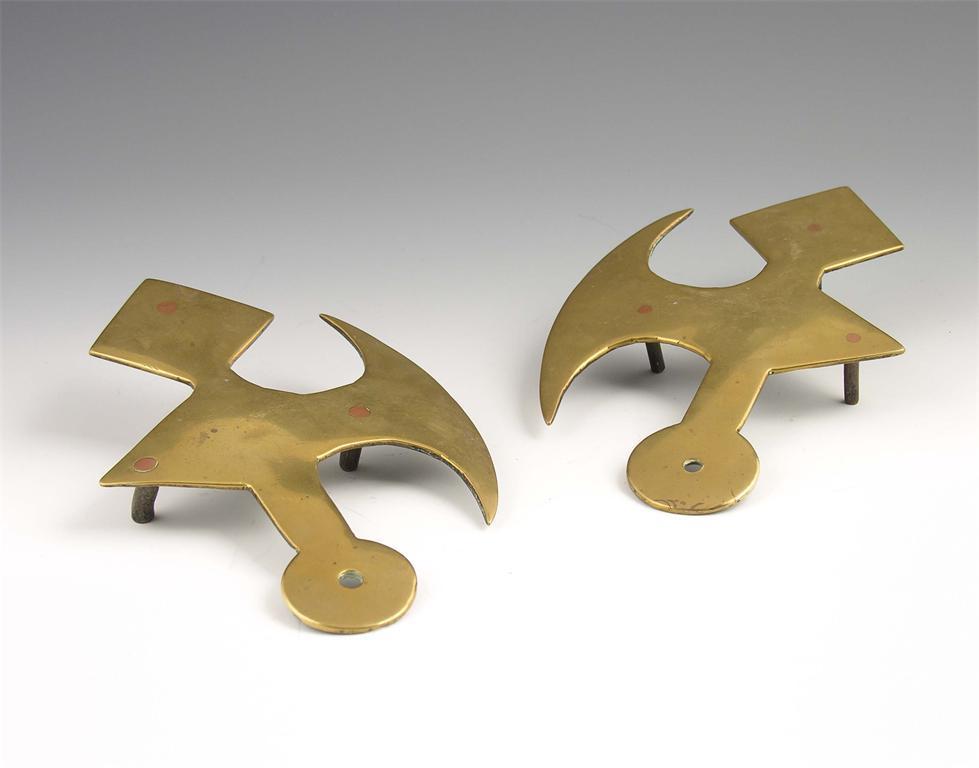 Appraisal: A pair of th century brass halberd axe head trivets