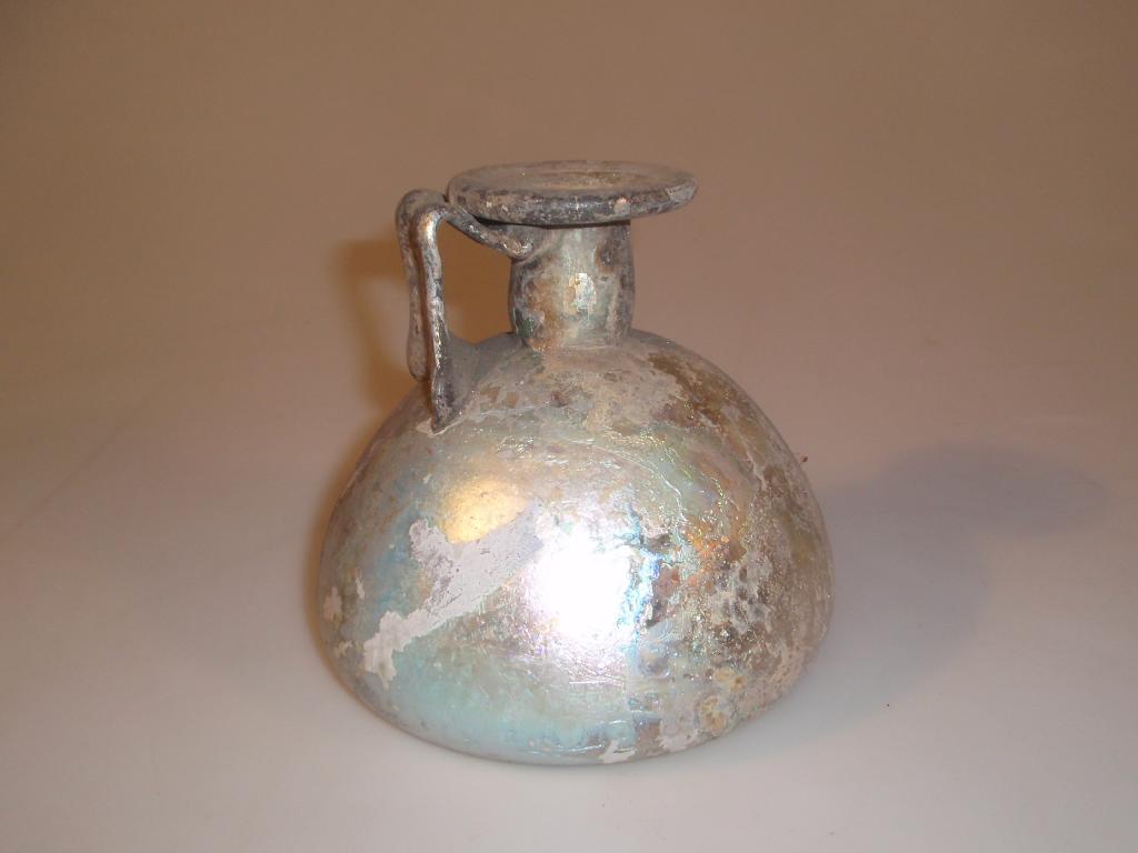 Appraisal: A restored light bluish-green Roman glass jug the everted folded