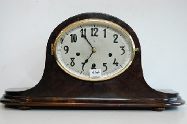 Appraisal: OVAL FAVE MANTLE CLOCK WESTMINSTER CHIME GUSTAV BECKER