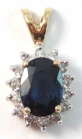 Appraisal: SAPPHIRE AND DIAMOND PENDANT k gold with round-cut diamonds surrounding