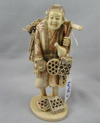 Appraisal: A JAPANESE IVORY CARVED FIGURE OF A BASKET PEDDLER The