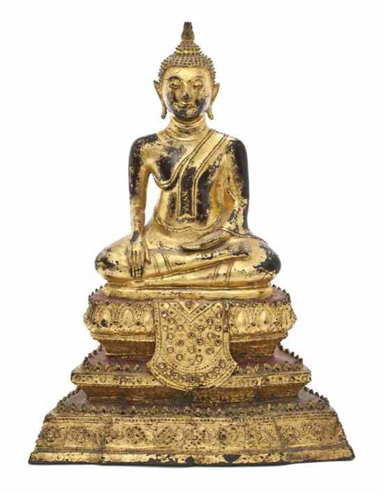 Appraisal: A Thai Gilt Bronze Buddha having a knot form hair