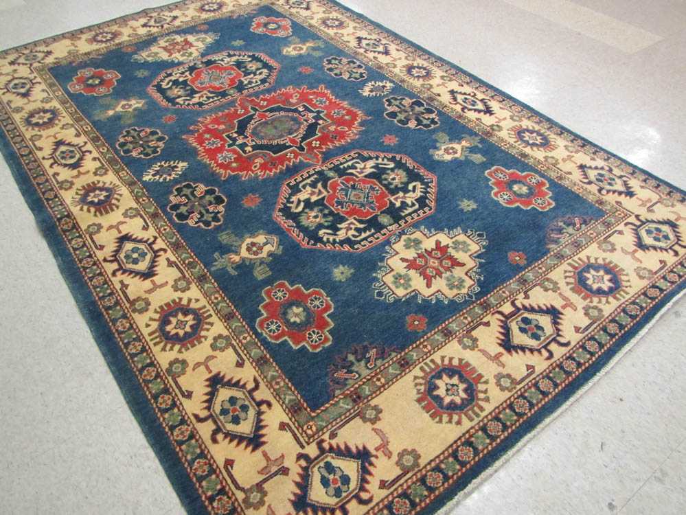 Appraisal: HAND KNOTTED ORIENTAL CARPET Pakistani Caucasian featuring numerous geometric medallions