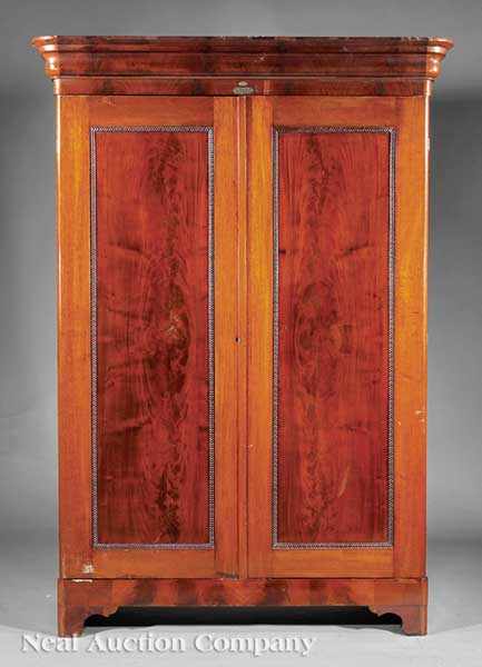 Appraisal: An American Classical Carved Mahogany Wardrobe molded cornice paneled doors