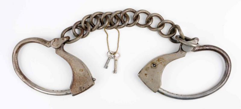 Appraisal: Towers Leg Irons Includes two keys Repair on one clevis