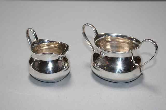 Appraisal: A HAND RISEN SILVER SUGAR BASIN with hoop handles and