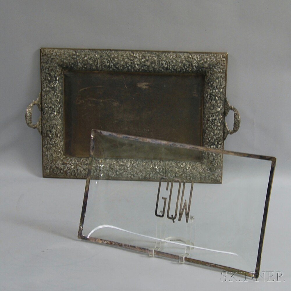 Appraisal: Two Serving Trays a large repousse silver-plated two-handled tray with