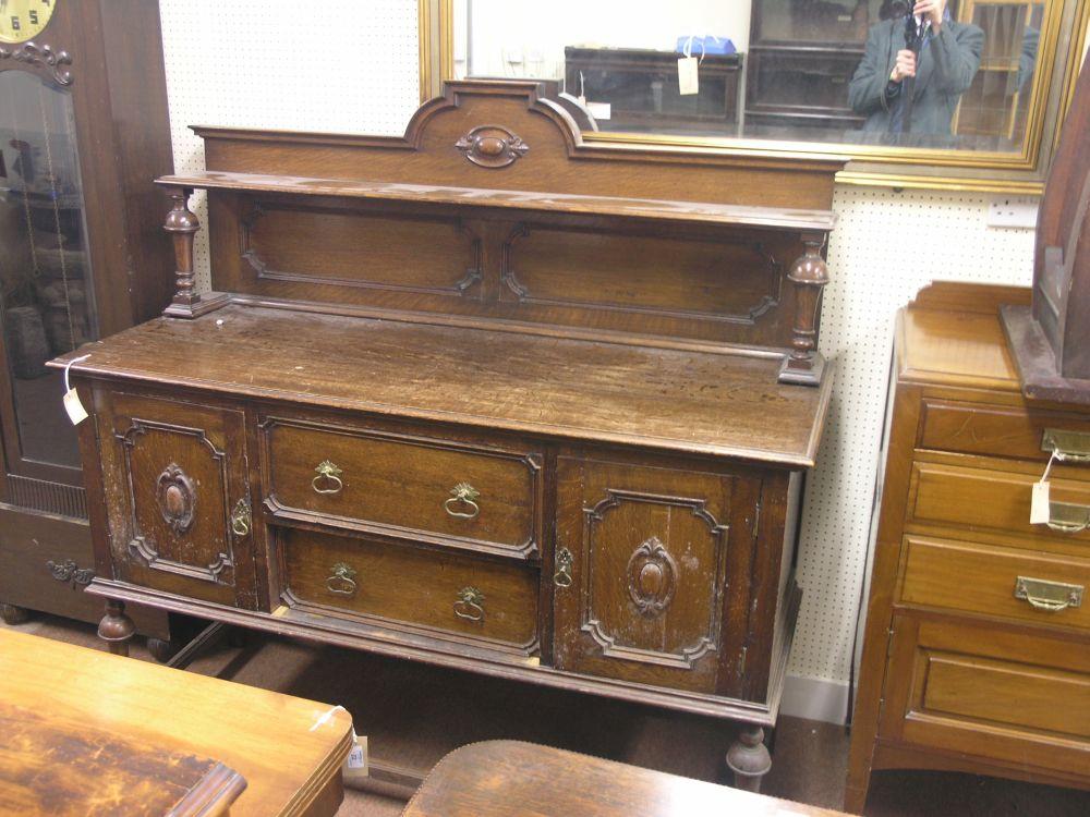 Appraisal: An early th century solid dark oak sideboard raised back