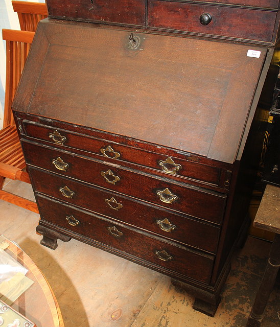 Appraisal: A GEORGE III OAK BUREAU the fall front enclosing a