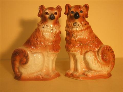 Appraisal: PAIR OF STAFFORDSHIRE SEATED COLLIES With gilt collars and chains