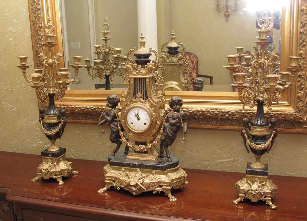 Appraisal: IMPERIAL FIGURAL CLOCK GARNITURE SET Figural pan children cast metal