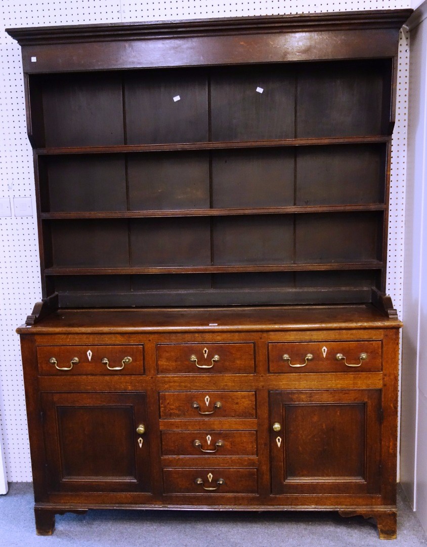 Appraisal: A George III oak dresser the enclosed three tier plate