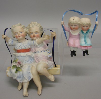 Appraisal: Pair of all bisque swing figurines Both have two girls