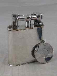 Appraisal: A plated Dunhill petrol table lighter c together with a