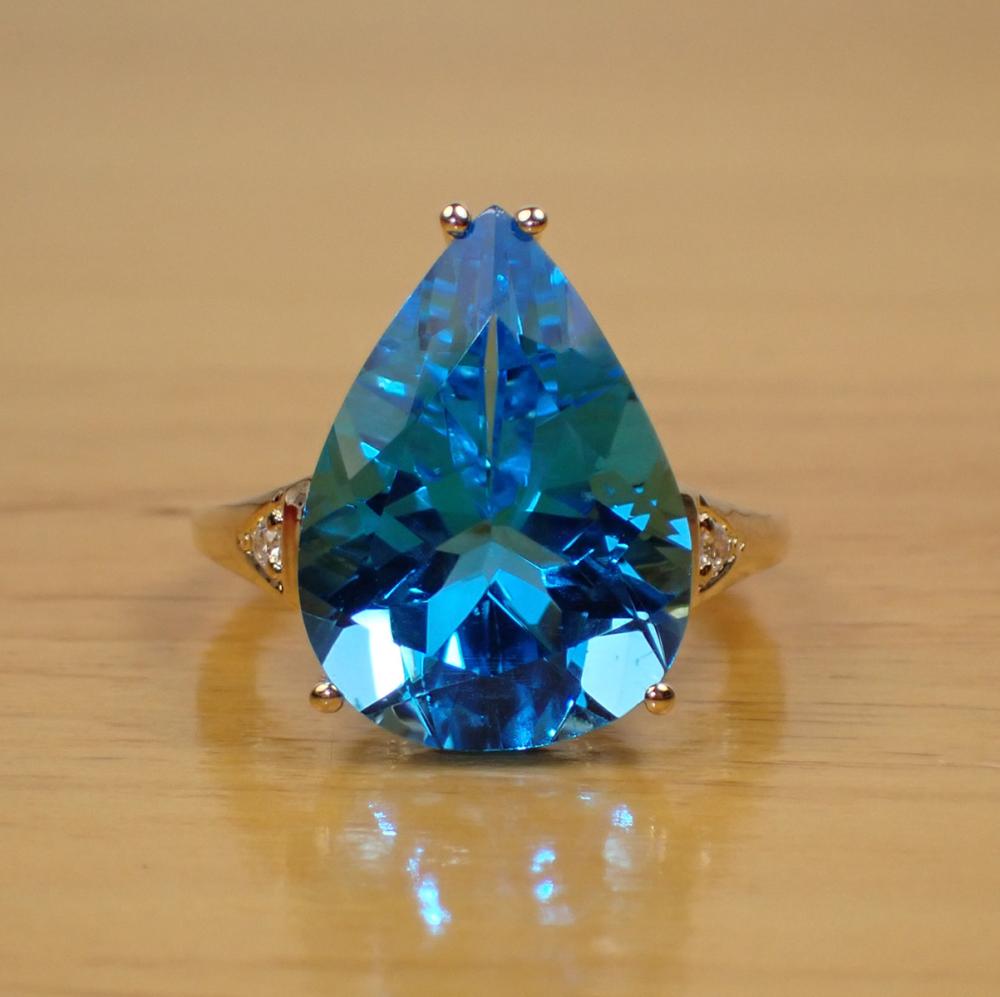 Appraisal: BLUE TOPAZ DIAMOND AND FOURTEEN KARAT GOLD RING with a