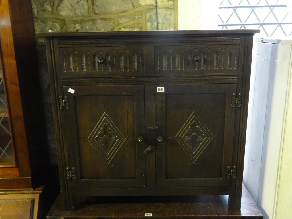 Appraisal: A small reproduction oak dresser base in the old English