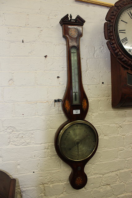 Appraisal: A GEORGE III MAHOGANY WHEEL BAROMETER the eight inch silvered