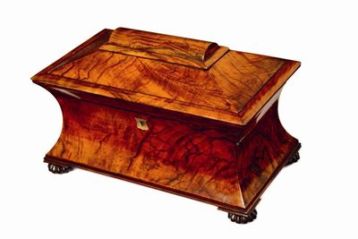 Appraisal: A Victorian figured walnut waisted sarcophagus shaped tea caddy with