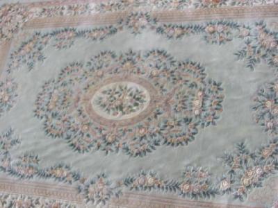 Appraisal: A CHINESE WASHED AND FRINGED CARPET the pale green field