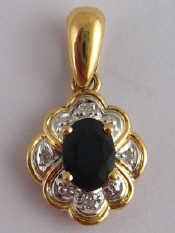 Appraisal: A yellow metal tests carat gold sapphire and diamond pendant