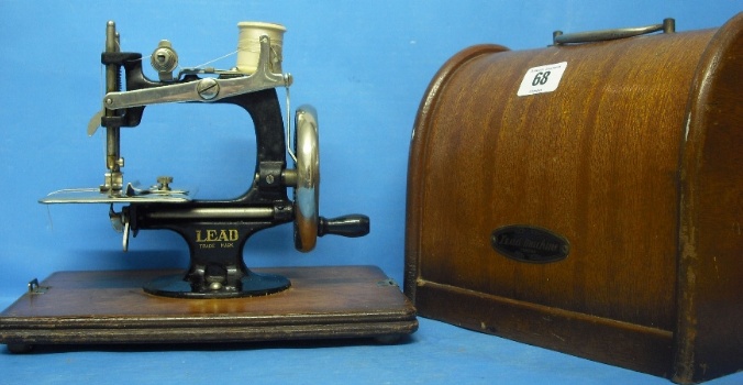 Appraisal: Small Sewing Machine Made by Lead in Wood carrying Case