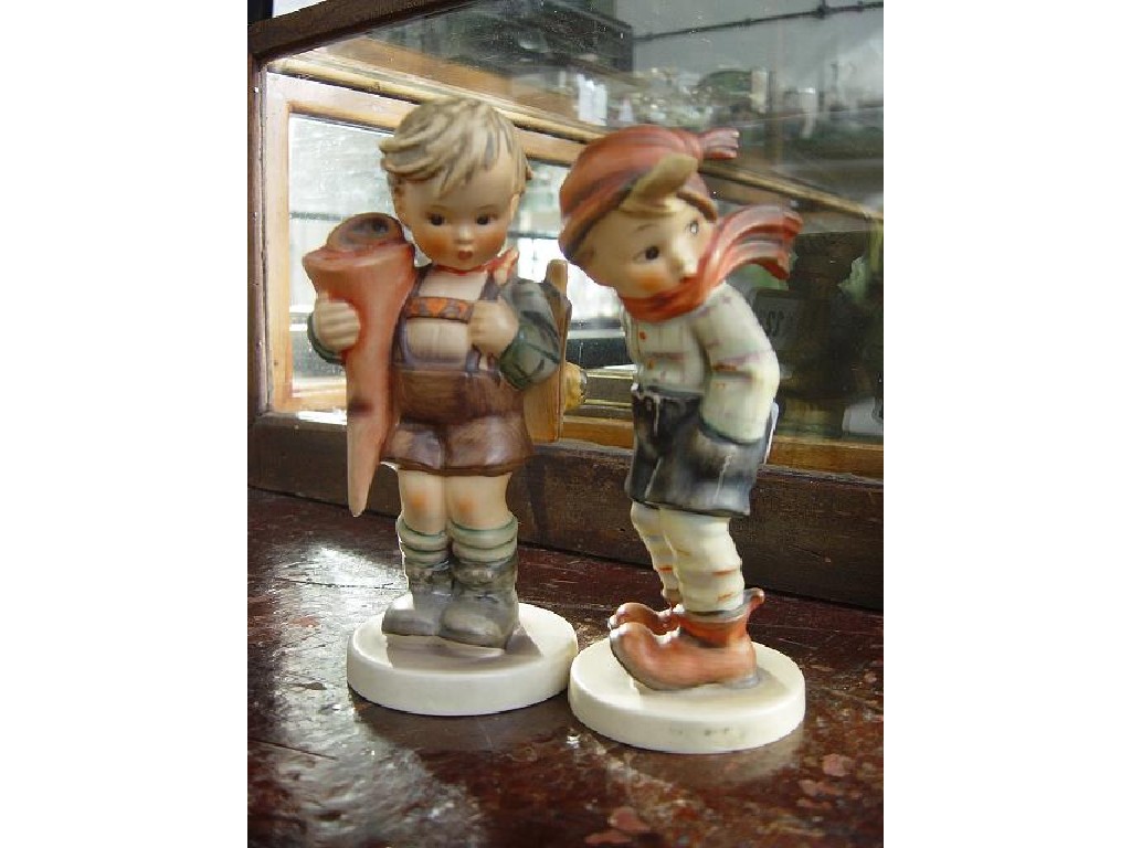 Appraisal: Two Hummel figure groups one of a boy wearing a