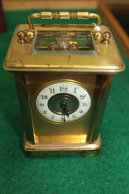 Appraisal: A LAQUERED BRASS CARRIAGE CLOCK the enamelled chapter ring with