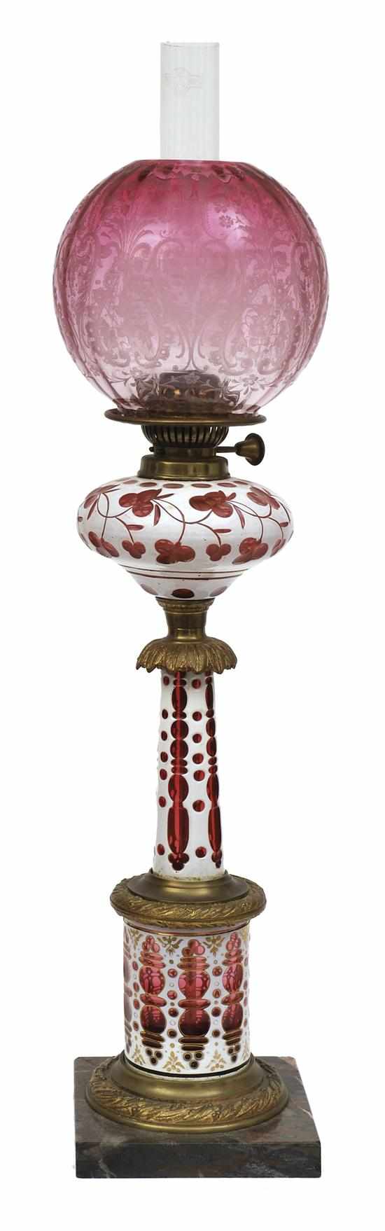 Appraisal: A BOHEMIAN OVERLAID RUBY GLASS KEROSENE LAMP AND RUBY SHADE