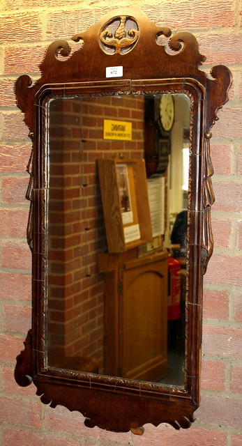 Appraisal: A GEORGE III MAHOGANY WALL MIRROR with fretted and pierced