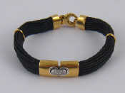 Appraisal: A yellow metal tests carat gold diamond set leather bracelet