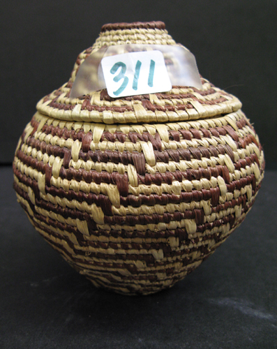 Appraisal: A HAND TWINED ESKIMO COVERED BASKET woven by Annie Hurlbut