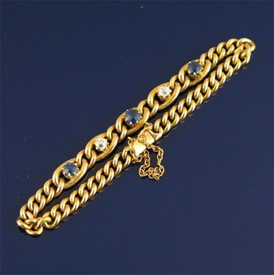 Appraisal: A gold curb link bracelet alternately set with three circular