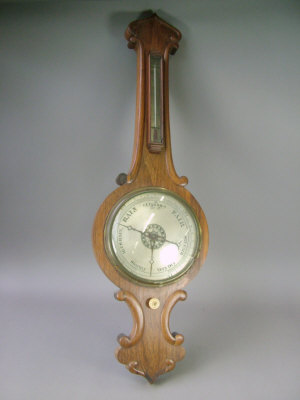 Appraisal: A Victorian rosewood cased wheel barometer with scroll carved decoration