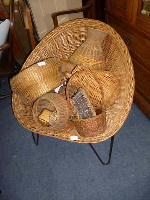 Appraisal: A CONTEMPORARY WICKER CHAIR with wrought iron supports and a