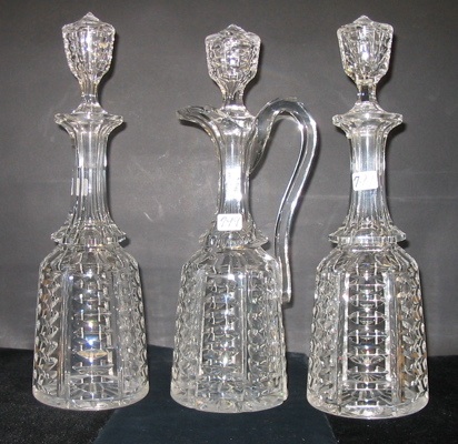 Appraisal: THREE CUT CRYSTAL WINE DECANTERS in matching pattern Two are