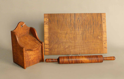 Appraisal: Tiger maple salt box h w together with a rolling