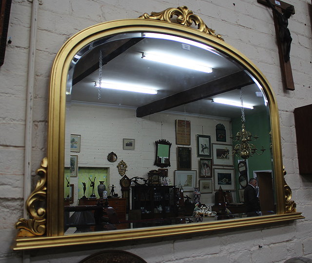 Appraisal: A GILT FRAMED OVERMANTLE MIRROR with acanthus leaf crest arching