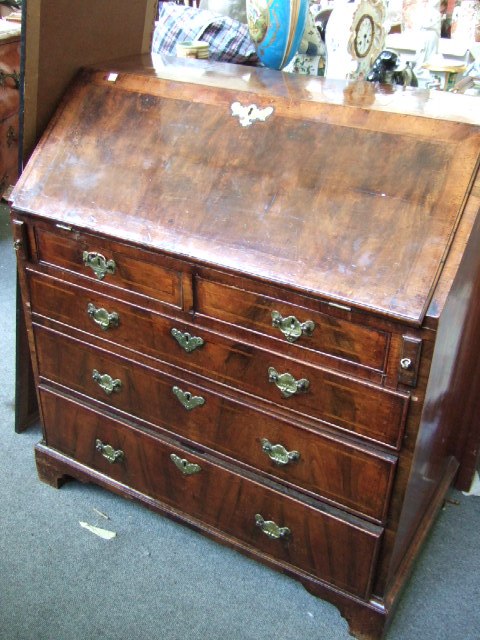 Appraisal: A George I walnut bureau the feather banded top over