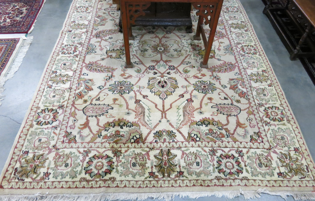 Appraisal: HAND KNOTTED ORIENTAL CARPET Indo-Persian overall floral design on khaki