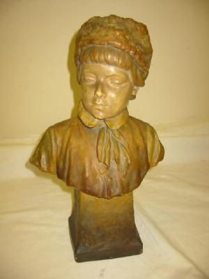 Appraisal: A GOLDSCHEIDER POTTERY BUST modelled as a boy wearing a