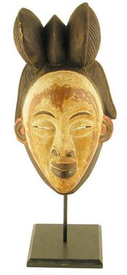 Appraisal: A Punu carved wood and polychrome decorated female mask on