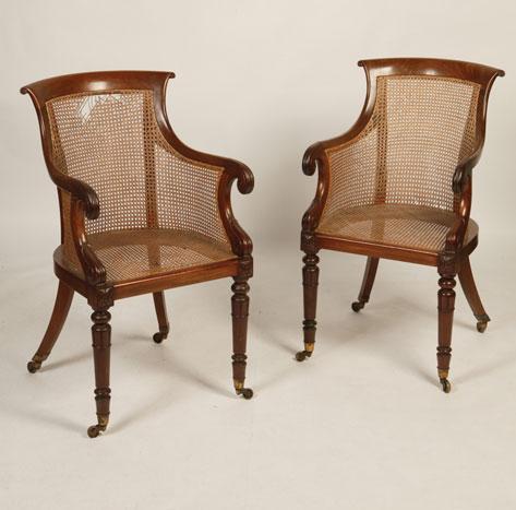 Appraisal: A PAIR OF MAHOGANY BERGERE ARMCHAIRS in the manner of