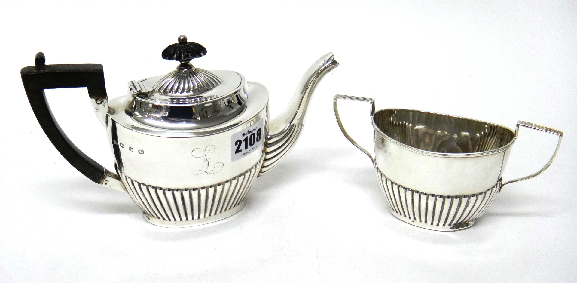 Appraisal: A silver teapot and a matching silver twin handled sugar