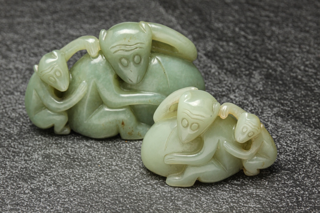 Appraisal: TWO CHINESE JADE MONKEY CARVINGS Twentieth century Similar forms in